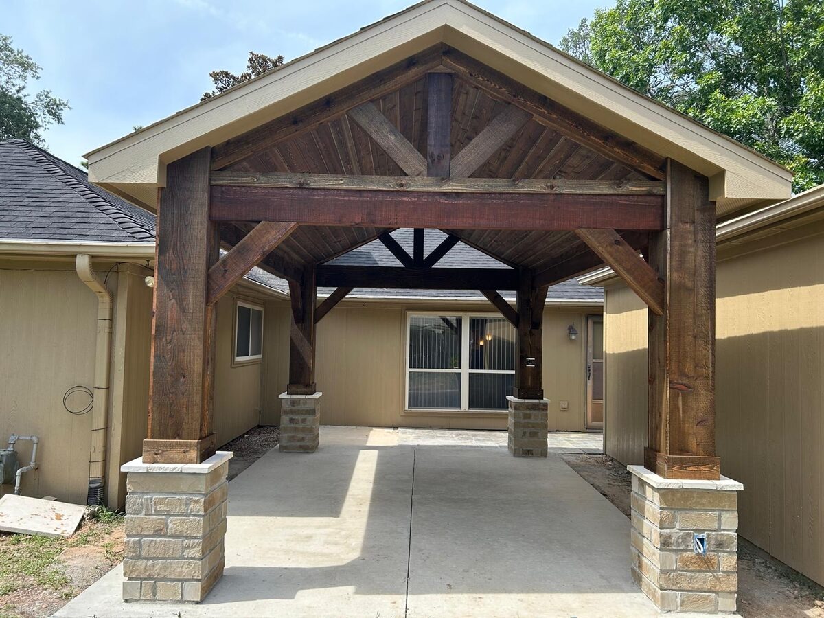 Freestanding patio cover with cedar timber posts on stone bases