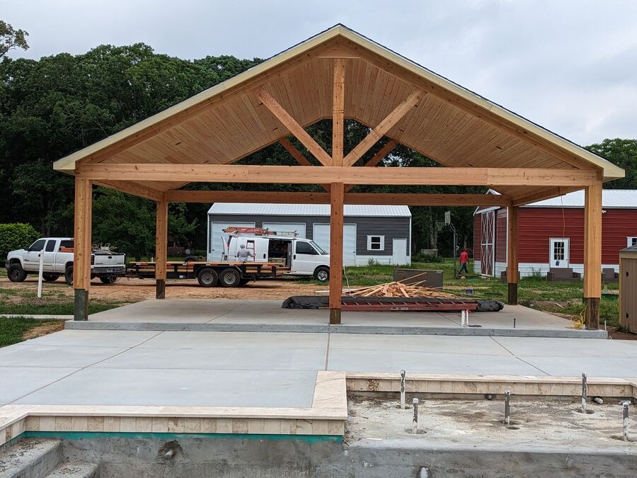 Freestanding gable roof patio pavilion with exposed cedar trusses