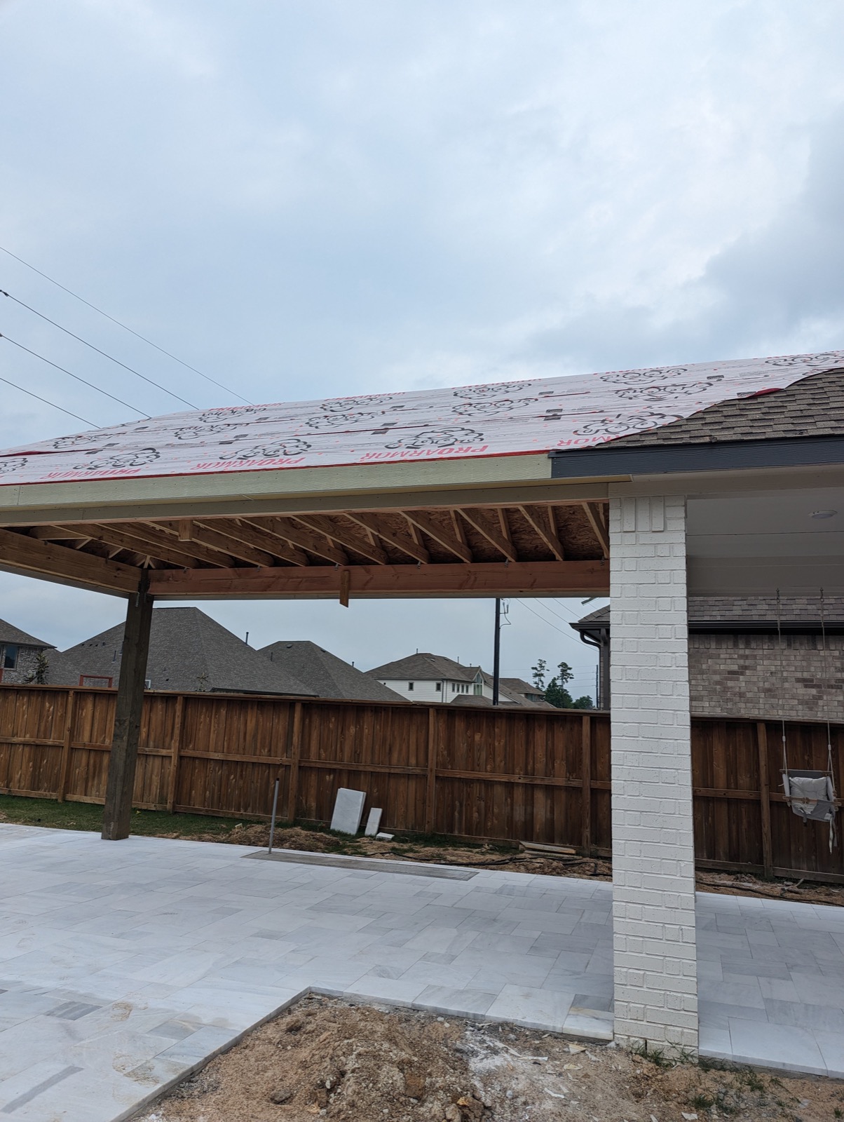Hip roof patio cover framing showing the hip rafters tying into the home's roof
