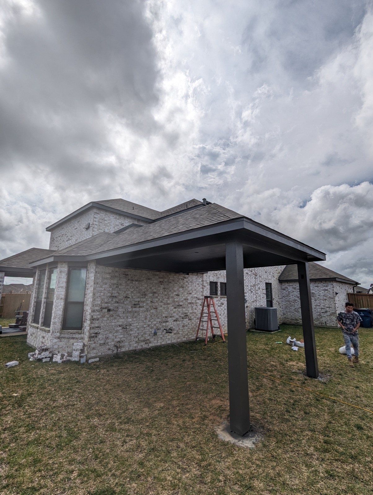 Finished hip roof patio cover matching the home's existing hip roofline