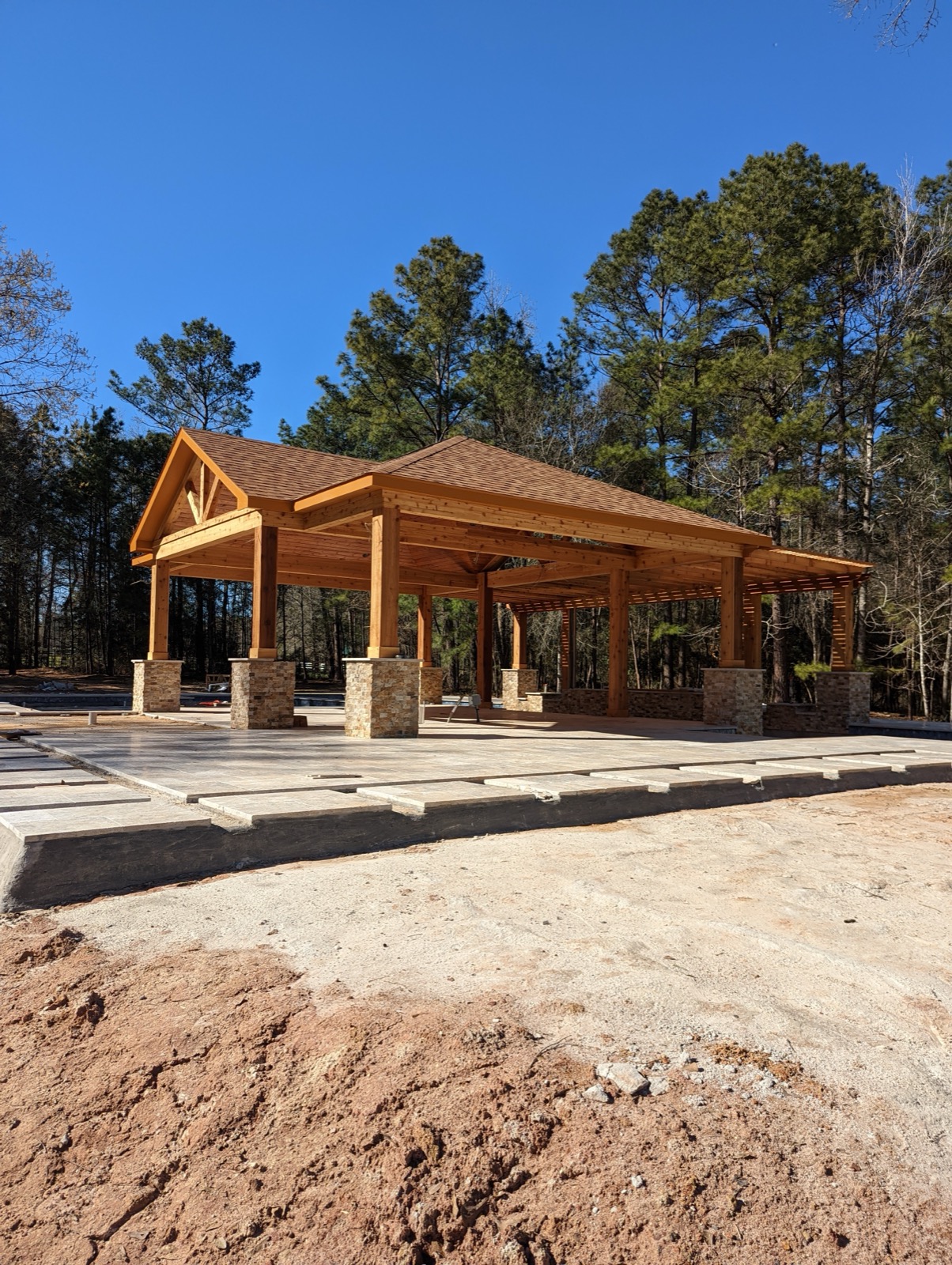 Large timber pavilion with open lattice pergola extension