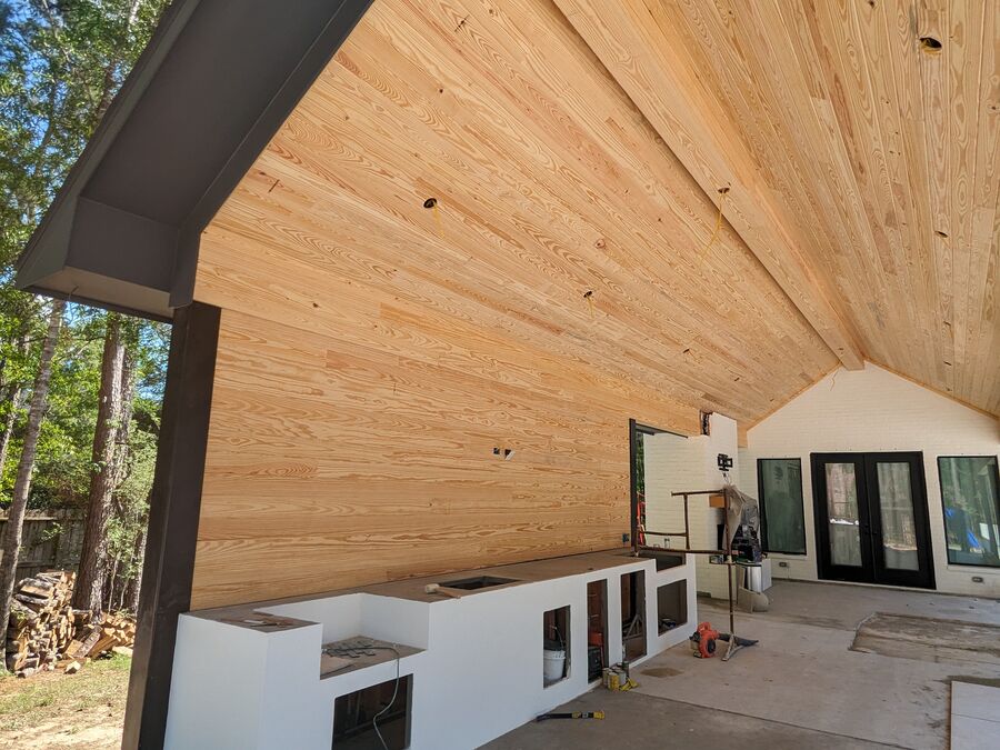 Patio cover with cedar ceiling and outdoor kitchen in Magnolia TX