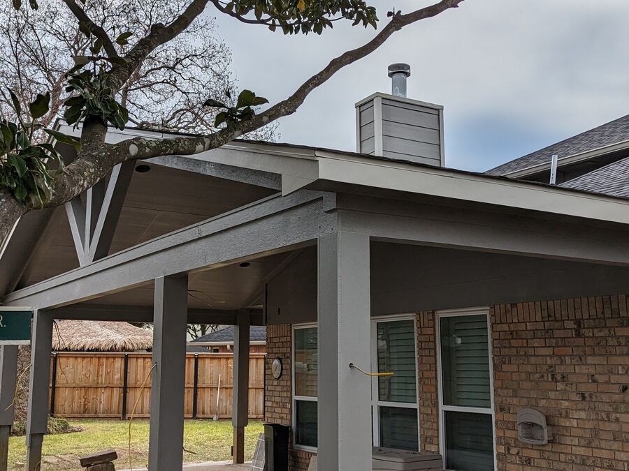Attached gable patio cover on brick home in Magnolia TX